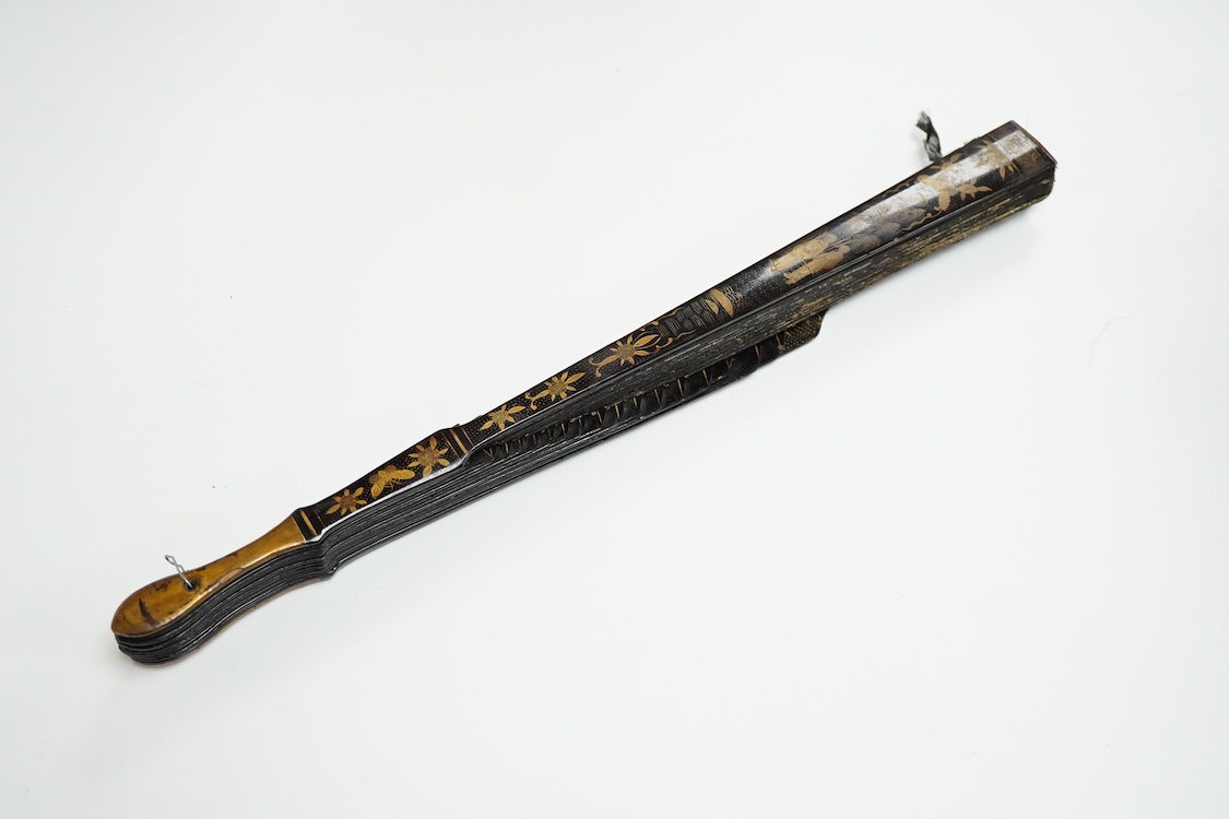 Four 19th century Chinese gilt-decorated black lacquer fans with figure painted leaves, two cased, largest 41cm
